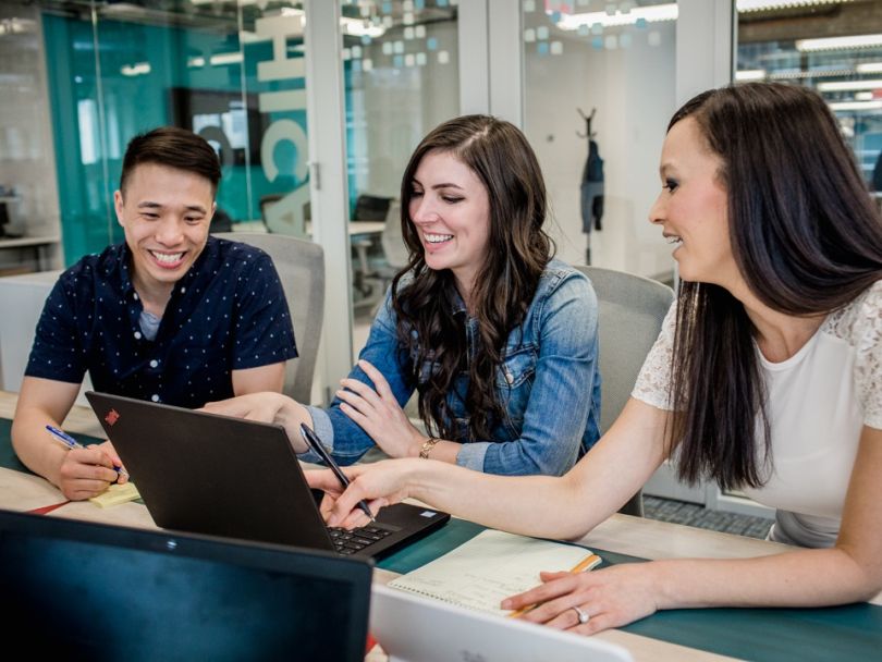 Pareto Intelligence team members working at a table