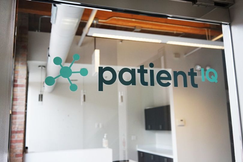 PatientIQ logo on a glass door at the office