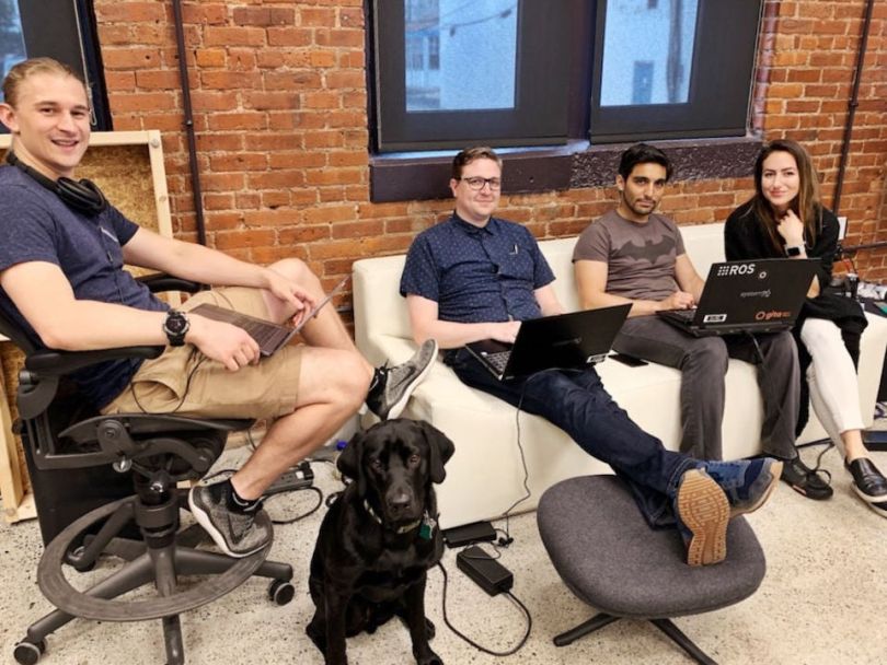 Piaggio Fast Forward team working on a couch