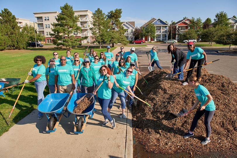 Pinnacol Assurance team members wearing company t-shirts doing volunteer landscaping work