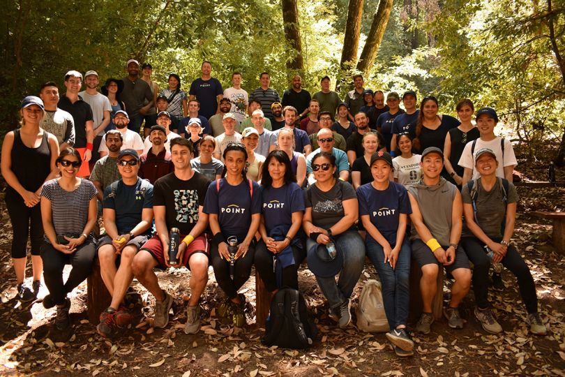 Point team members group photo outside in nature