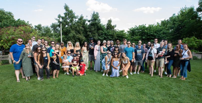 Group of people stand outside on grass