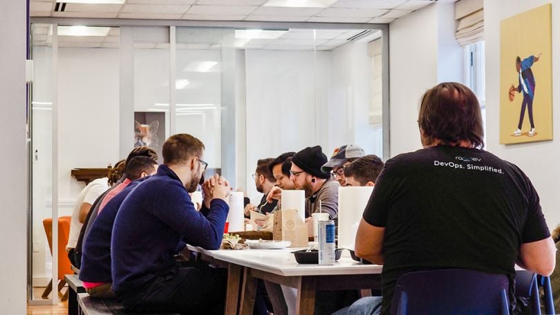 RapDev team members eating lunch together in the office