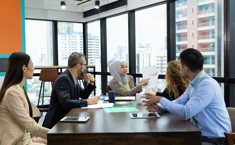 Diverse group of colleagues meeting in a modern office