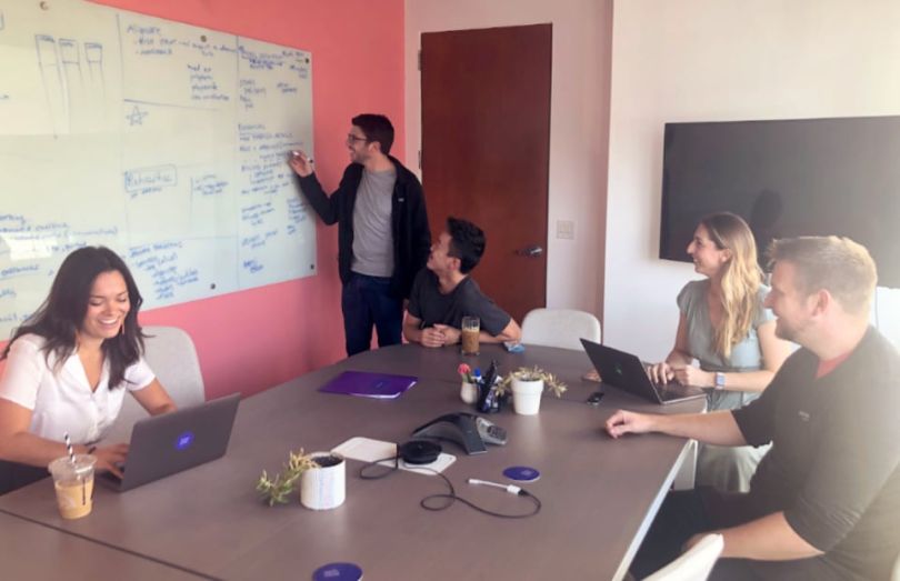 Renew Health team members working in a conference room