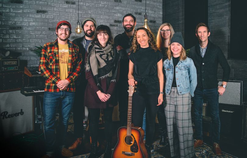 Reverb.com staff in a portrait with a guitar on the ground