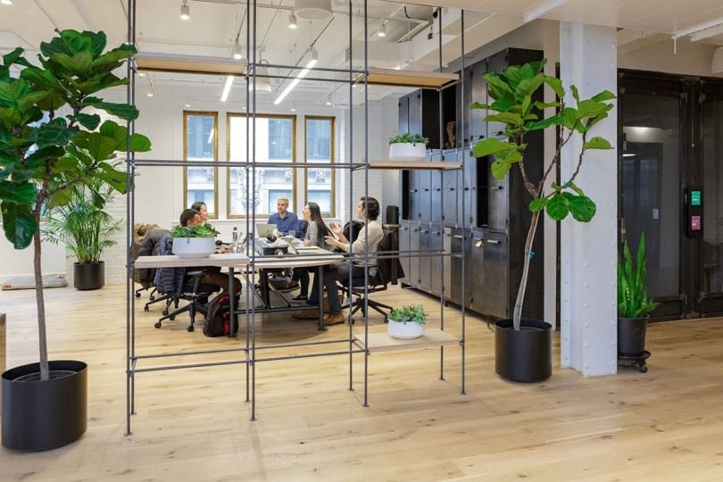 Team members having a meeting in the Riskified office