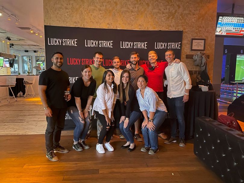 RudderStack team members at an upscale bowling alley