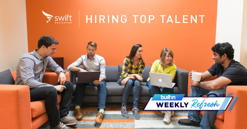 Members of the Swift Navigation team working and chatting in an orange office