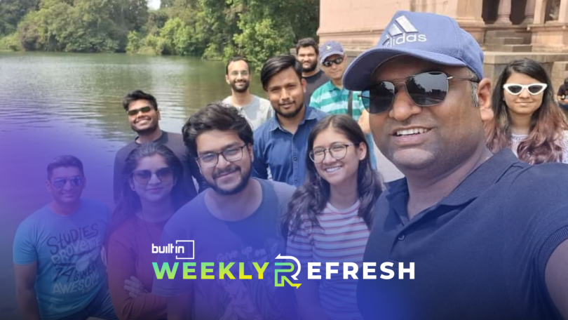 Members of the Stack Identity team pose for a group selfie outdoors.