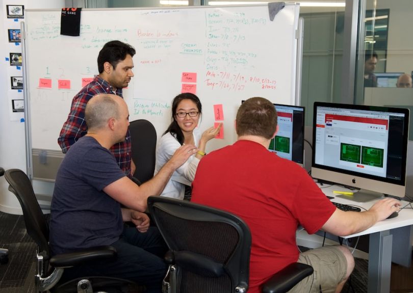 STATS team working together at a desk