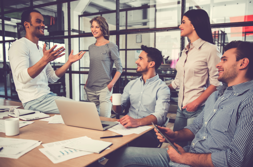 a team meets at a table to talk
