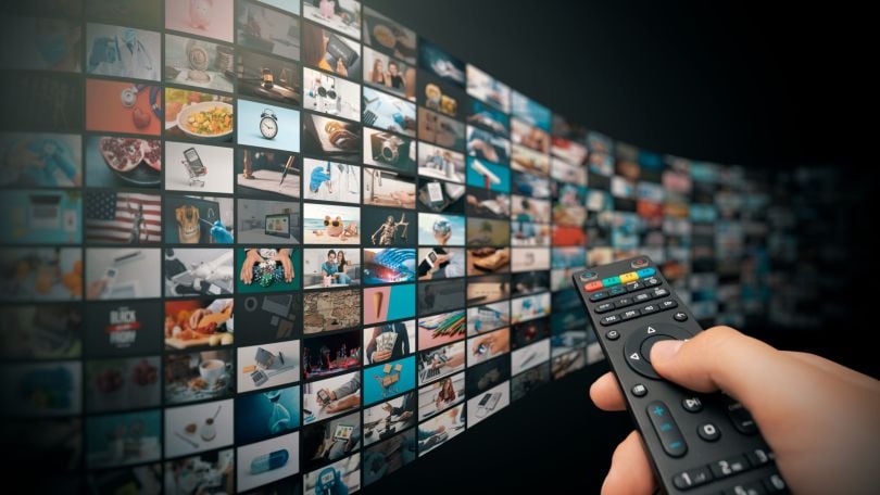 Someone skims through channels on a remote. 