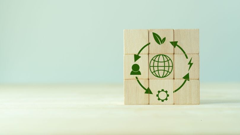 Stacked wooden blocks form an illustration depicting sustainable consumption. 