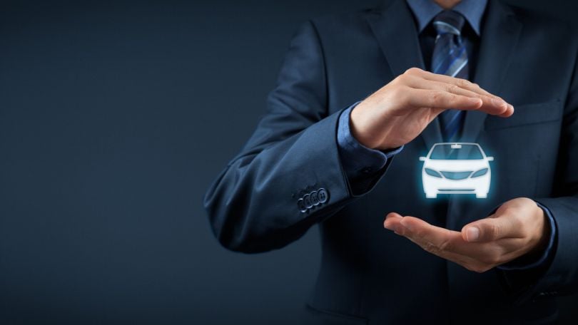 Hands presenting an icon of a car. 