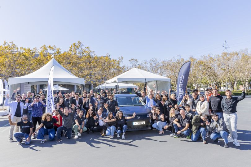 The Sibros team outdoors under an event tent