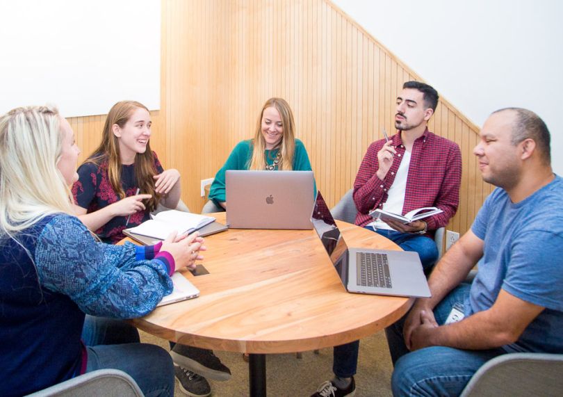 Simply Business team members chatting at a table