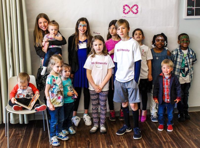 Children in Sittercity shirts posing for photo