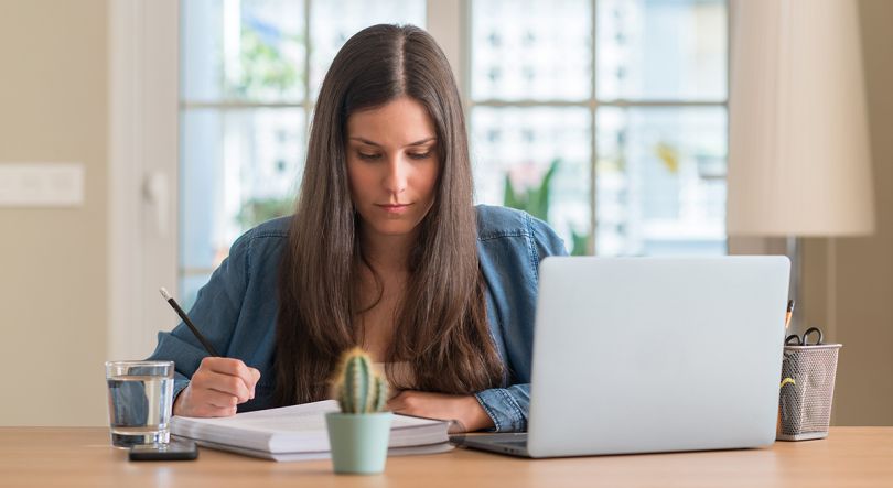 A woman sitting at a desk working from home