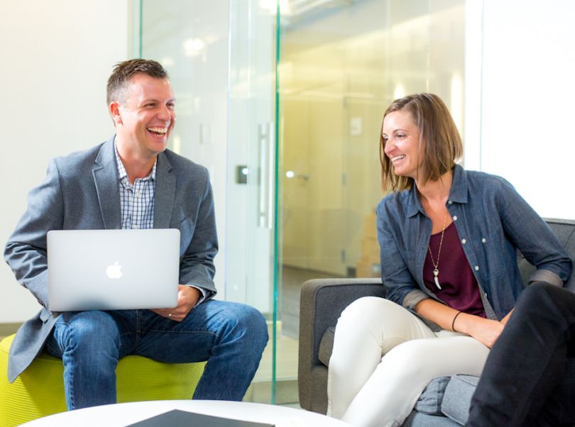 Solstice team members laughing in a conference room