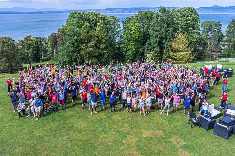 Sonar group photo at a park with a lake in the background