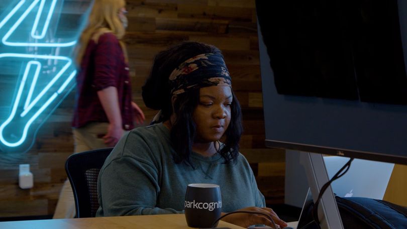 SparkCognition team member working on a computer in the office