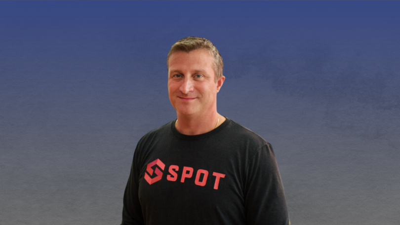 Spot co-founder Andrew Elsener against a blue and grey background.