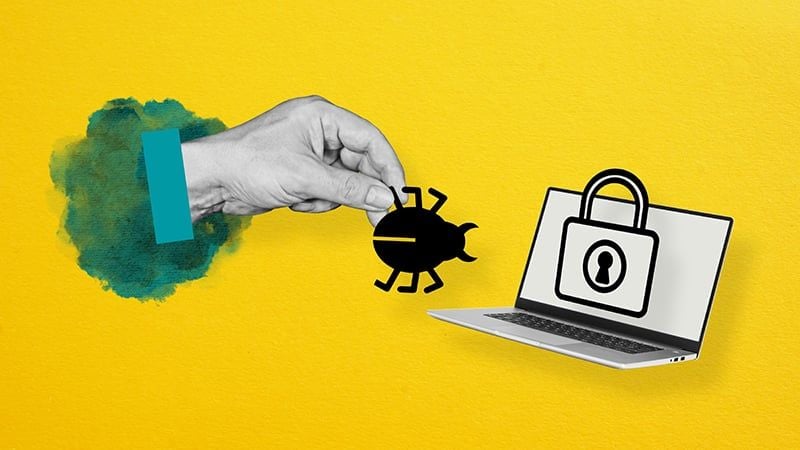  A hand removes a bug from a computer.&nbsp;
