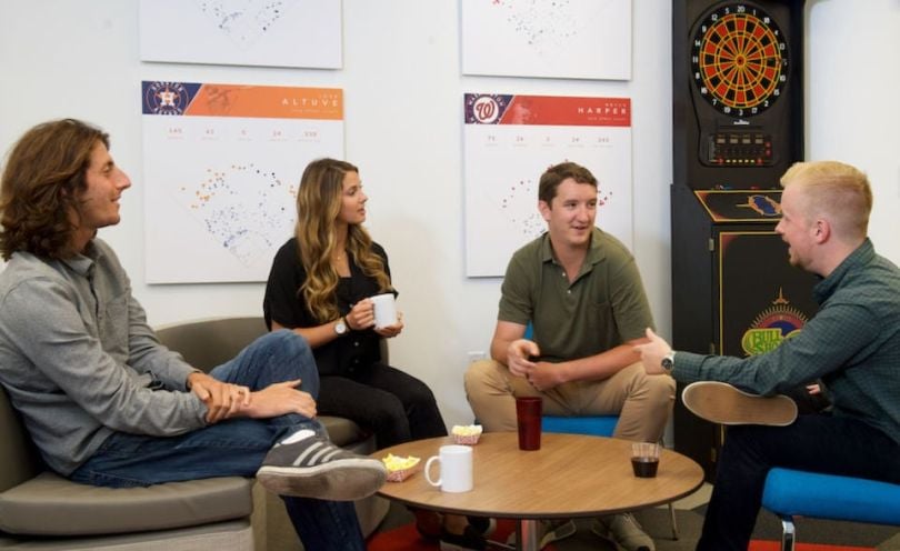 STATS Perform team chatting in their office