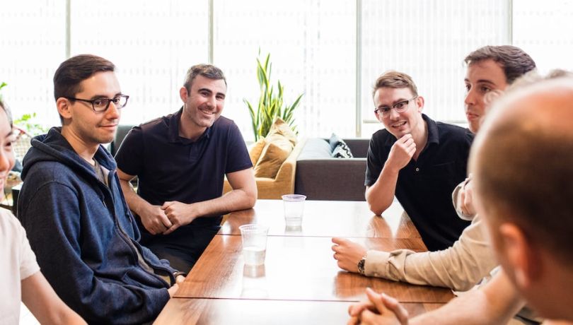 Strong Analytics leadership chatting around a table