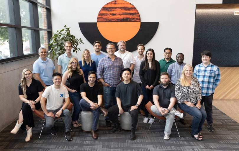 A group of Studio X employees together in the office.