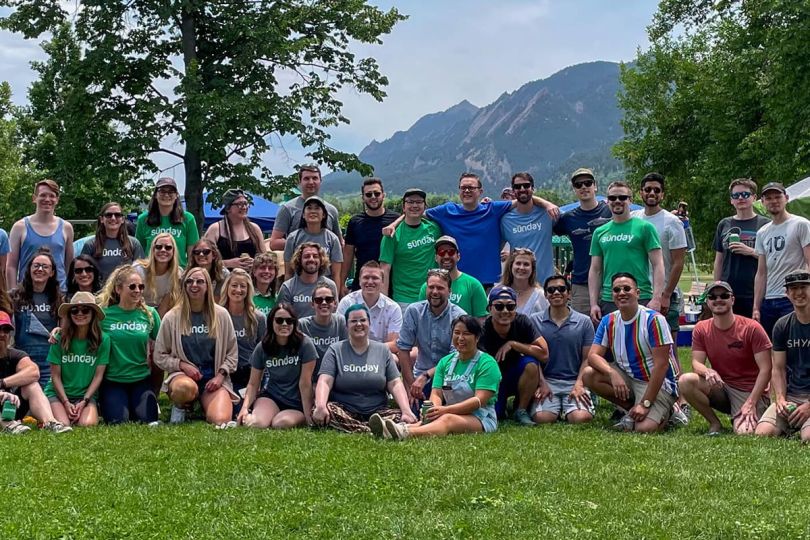 Sunday team members outside wearing company t-shirts