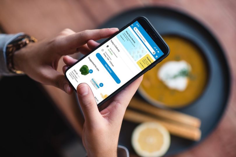 A close up of a phone screen with Sysco LABS' mobile shop