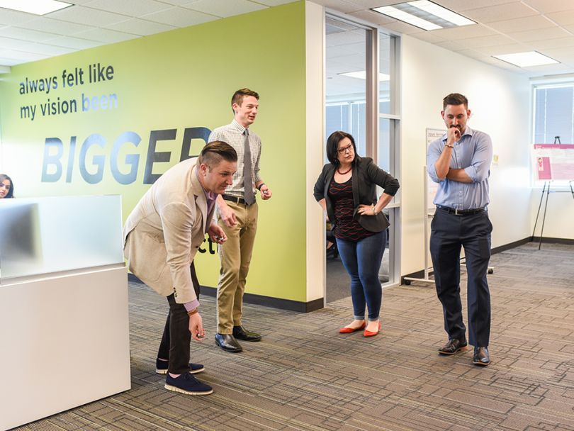 Social Solutions' team laughing in the office 