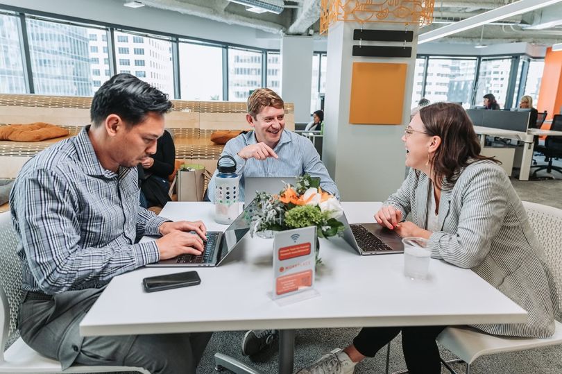 Toast colleagues sitting at a table in the office having a meeting