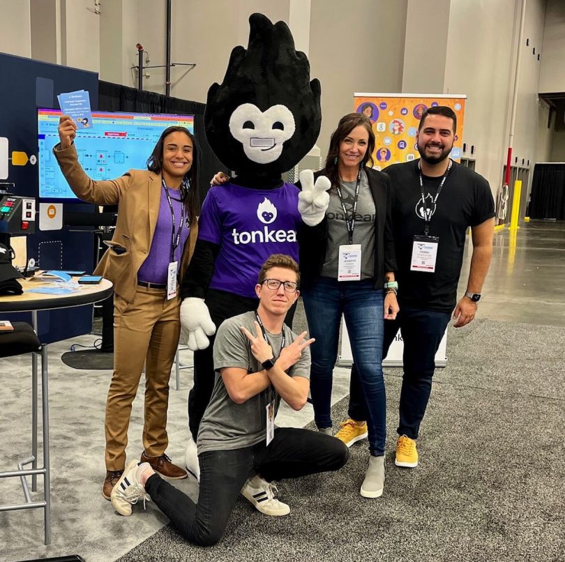 Four members of the Tonkean team pose with the company mascot
