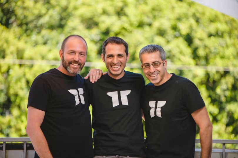 Three Torii team members wearing matching t-shirts with the company logo