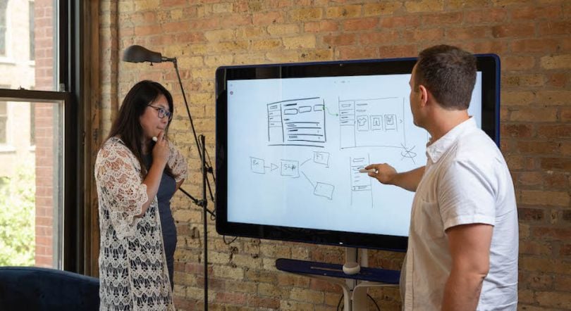 Trunk Club team members working at digital white board