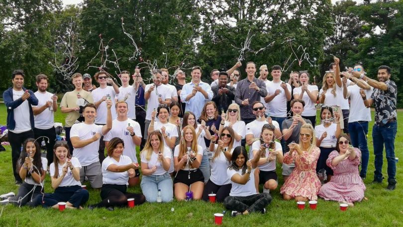 Reachdesk team members pose for a lively group photo at a summer party.