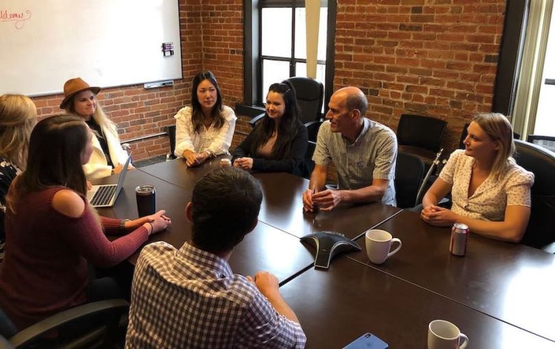 Udemy team members talking in conference room