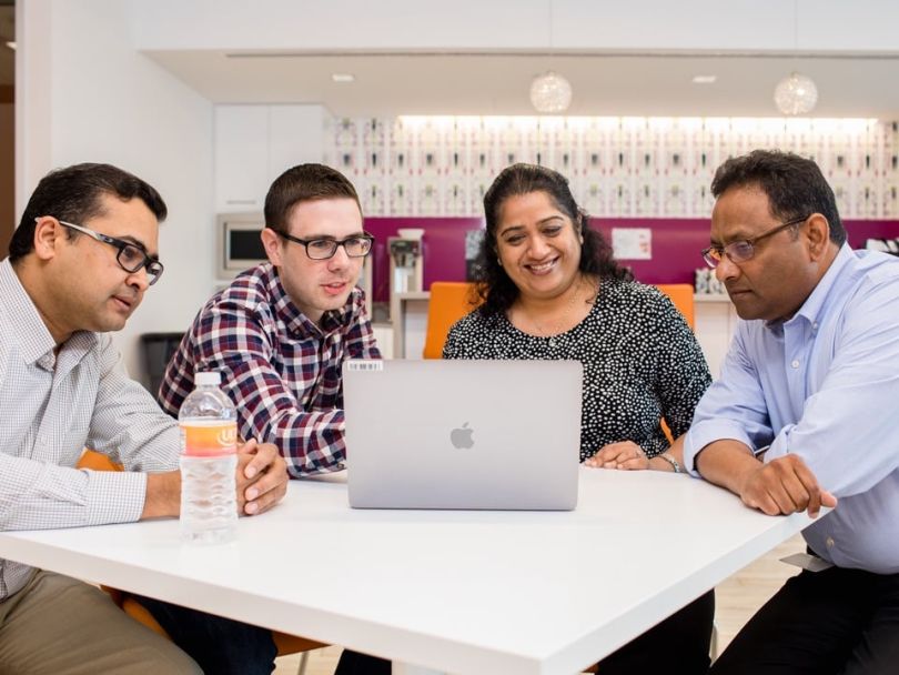 Ulta Beauty team members working at a laptop