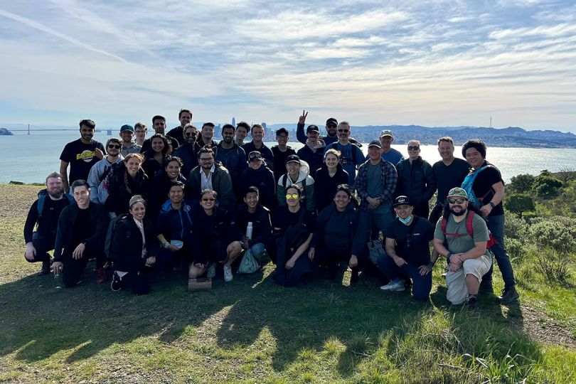 Unit21 team outside with the Golden Gate Bridge and ocean in the background