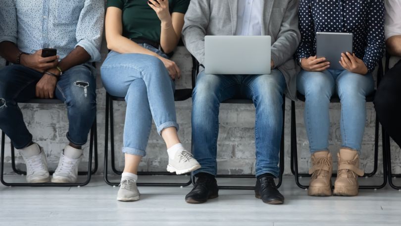 Stock photo of a group of candidates in a waiting room.