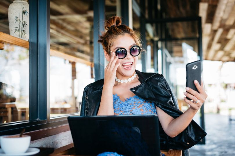 Woman takes a photo of herself in cafe