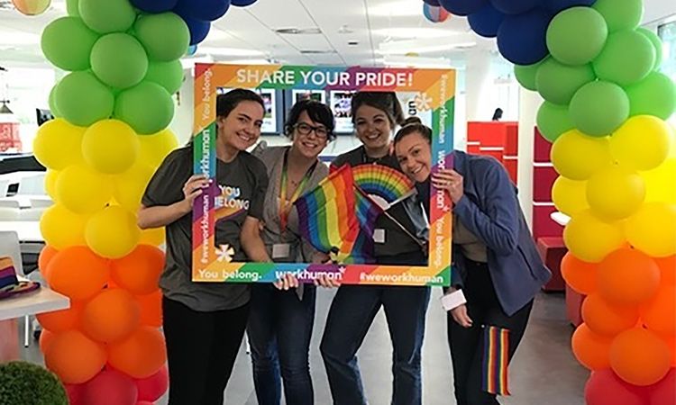 Workhuman team members with rainbow pride decorations
