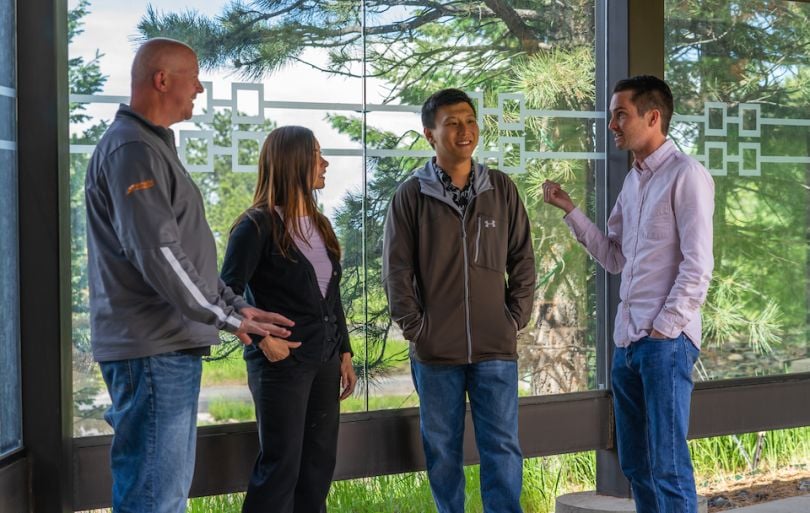Wowza Media Systems team chatting near a window