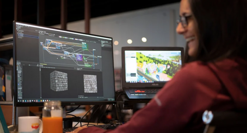 A Zwift employee laughs while working on a project.