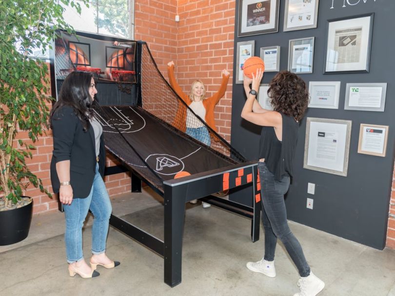Earny's team playing basketball in the office