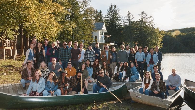 The Org team members pose for a group photo at an outdoor event. 