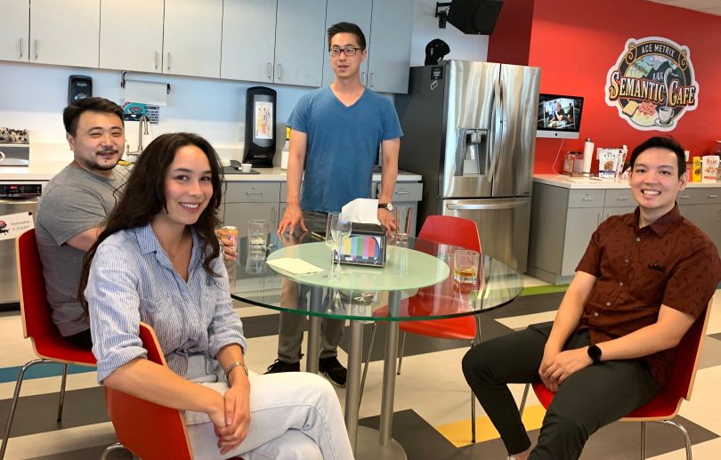 Ace Metrix team members gathered together at company kitchen cafe